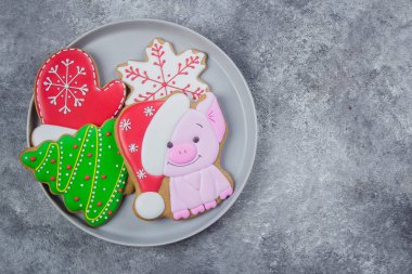 Mutlu yeni yıl ve mutlu Noeller gingerbread gri taş zemin üzerine plaka üzerinde. Yıl 2019 - domuz ve çeşitli diğer kurabiye sembolü. Üstten görünüm, kopya alanı