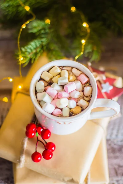 Winter warming sweet drink hot chocolate with marshmallows in mug with Christmas holiday festive decoration