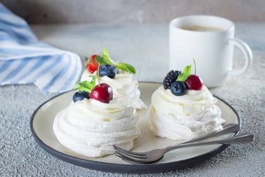 Snack Kahvaltı Konsepti. Bir tabak ve fincan witj latte kahve taze çilek ile Beze tatlı Pavlova kek. Taş arka plan, yakın çekim