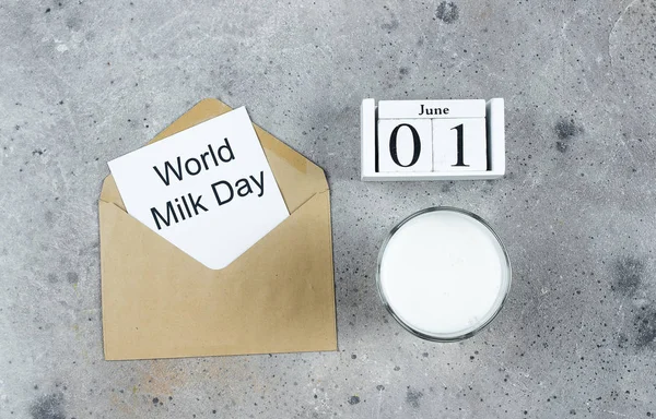 World Milk Day. Full glass of milk on stone table. Dairy, health