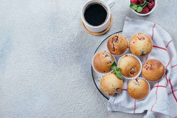 Delicious breakfast food concept. Coffee, raspberry muffins on l