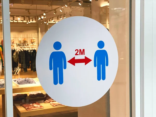 Sticker keep distance on the glass in store in the mall. Concept of keep distance, social distancing, quarantine or isolation