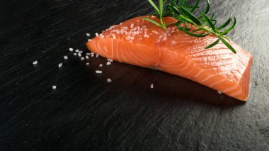Somon fileto dilim. Taze kırmızı balık ya da alabalık doğal siyah arka plan üzerine kalın parça