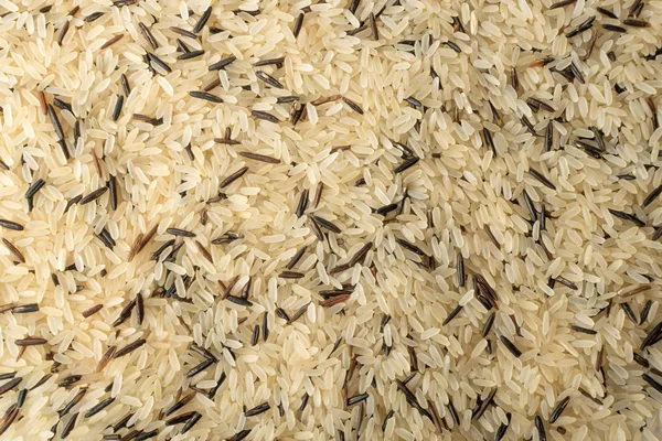 Mix of Raw Black Wild Rice and Parboiled White Rice Top View. Background or Pattern with Healthy Dietetic Canada Rice