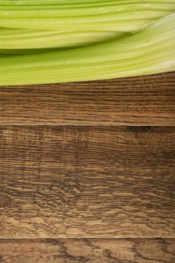 Ham yeşil kereviz ahşap arka plan üstten görünüm üzerinde takip ediyor. Eski ahşap rustik masa metin veya boşaltmak için yer ile taze organik sebze