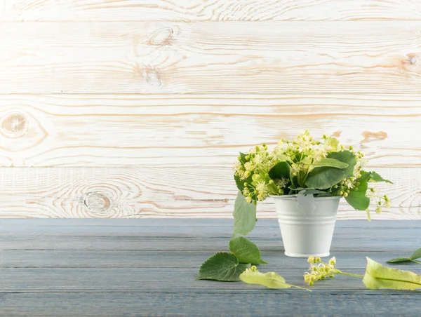 Ihlamur çiçek ahşap arka plan üzerinde. Güzel yaz buket ahşap masa doku üzerinde. Ihlamur çiçeği ile metin için yer