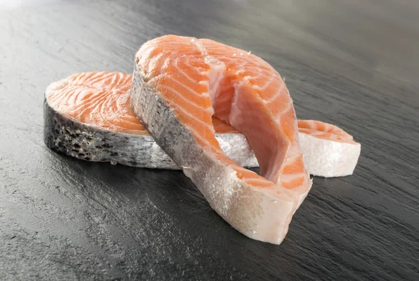 Doğal siyah arka plan üzerine çiğ somon Steak dilim. Taze kırmızı balık veya görünümünün alabalık en iyi yer ile metin için kalın parça