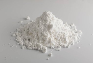White Powder of Gypsum, Clay or Diatomite Isolated on Grey Background. Macro Photo of Powdered Chemicals as Calcium, Gypsum or Plaster Close Up clipart