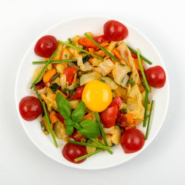 Fried Vegetable Mix with Zucchini, Sweet Pepper, Cherry Tomatoes, Onions Close Up. Restaurant Serving Vegetarian Dish of Diced Cooked Vegetables and Greens Top View clipart