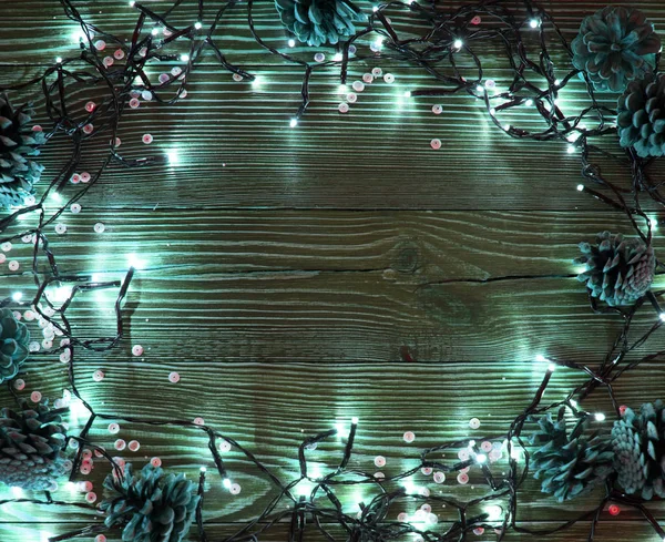 Christmas Light on Wooden Background Top View with Copyspace. Garland Lights on Vintage Wood Texture for New Year Frame or Xmas Mockup