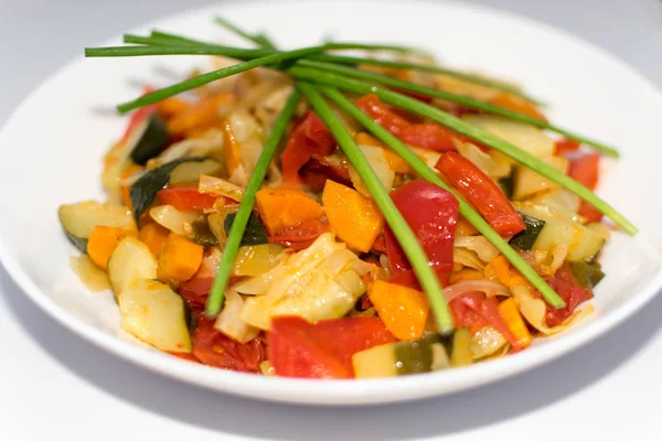 Fried Vegetable Mix with Zucchini, Sweet Pepper, Cherry Tomatoes, Onions Close Up. Restaurant Serving Vegetarian Dish of Diced Cooked Vegetables and Greens