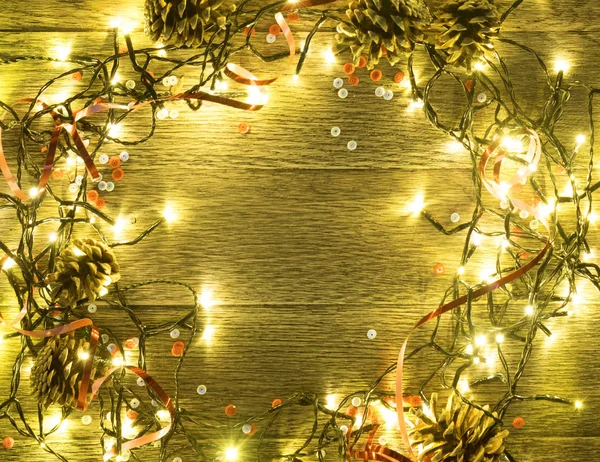 Christmas Light on Wooden Background Top View with Copyspace. Garland Lights on Vintage Wood Texture for New Year Frame or Xmas Mockup