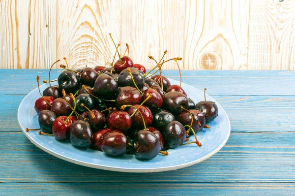 Plate Fresh Ripe Cherries Old Wooden Background Design Montage Blue — Stock Photo, Image