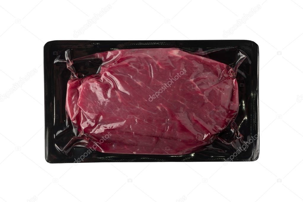 Vacuum black plastic pack with fresh beef steak isolated on white background. Raw meat packed without label top view