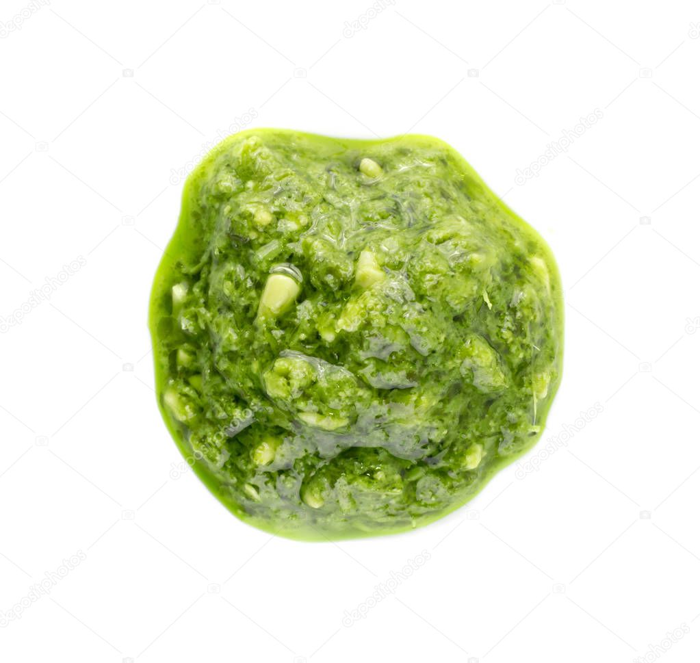 Pesto spread or blob isolated on white background. Green italian homemade spilled sauce made of ground basil, garlic, pine seeds, olives and pecorino sardo cheese top view
