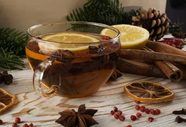 Hot winter drink with spices on festive new year background