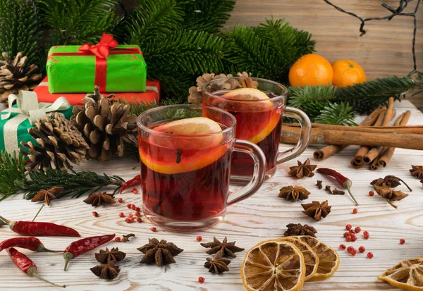 Winter red drink with spices on festive new year background