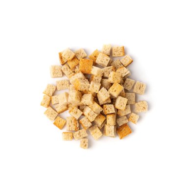 Pile of homemade bread croutons isolated on white background top view. Crispy bread cubes, dry rye crumbs, rusks, crouoton or white roasted crackers cube heap clipart