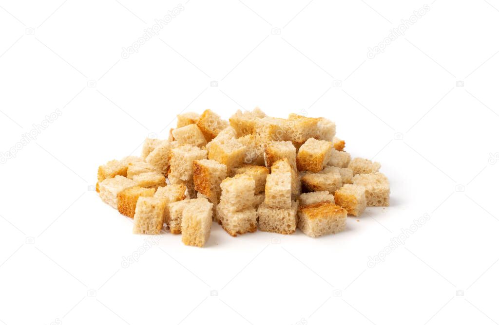 Pile of homemade bread croutons isolated on white background side view. Crispy bread cubes, dry rye crumbs, rusks, crouoton or white roasted crackers cube heap