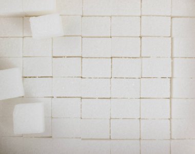 Beyaz şeker küpleri arka plan üst görünümü desenli. Kopyalama alanı olan rafine edilmiş beyaz şeker kalıbı