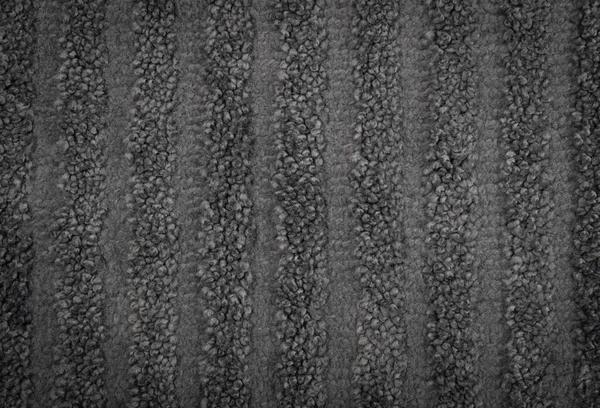 Gray striped carpet texture background top view. Dark grey nylon carpeting or mat with stripes pattern, floor covering wallpaper. Soft polyester carpet rug mockup with copy space
