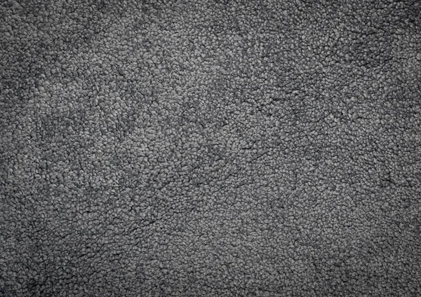 Gray carpet texture background top view. Dark grey nylon carpeting or mat pattern, floor covering doormat wallpaper. Soft polyester carpet rug mockup with copy space