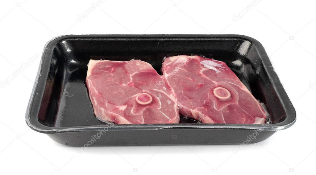 Raw lamb chops or mutton cuts in vacuum packaging isolated on white background. Fresh sheep meat cutlet on bone cut out closeup
