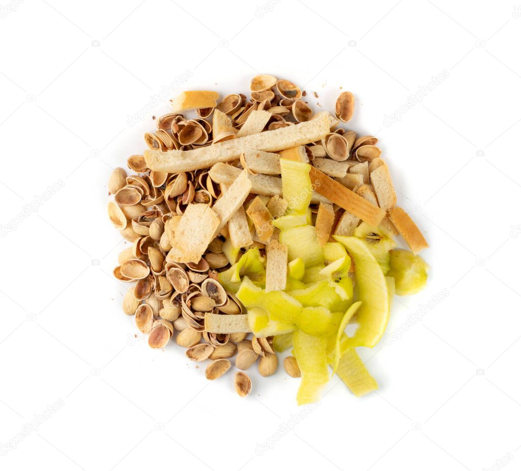 Pile of pistachios husks, bread crusts and apple peel isolated on white background. Bio garbage mix for compost top view. Organic waste ingredients