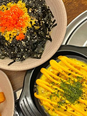 Steamed Korean egg dish, Gyeran Jjim, known for its light, fluffy texture. Served hot, often in an earthenware pot, this savory and comforting dish pairs well with rice and banchan.