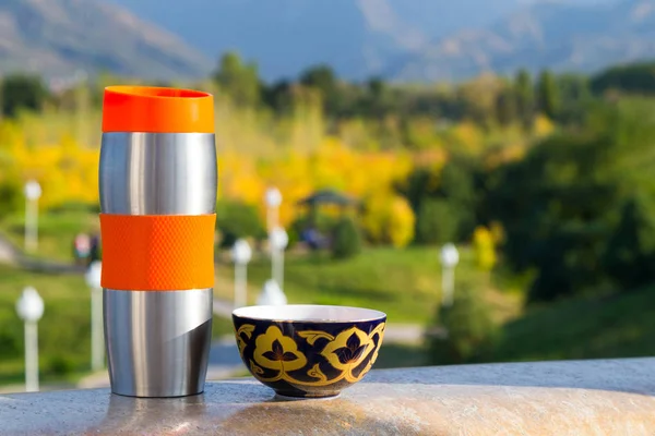 Vacuum flask & cup outdoors