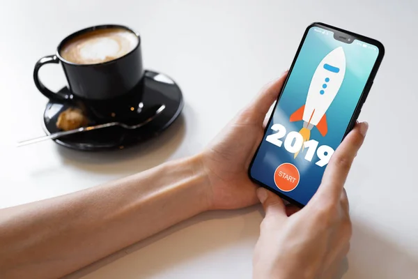 2019 year Rocket start button on mobile phone screen. Business concept. — Stock Photo, Image