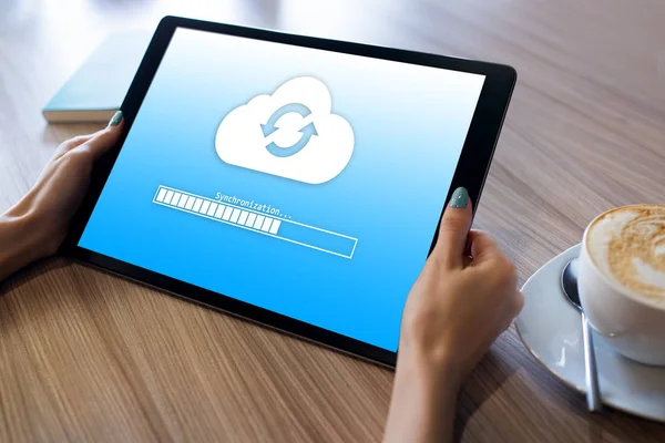 Cloud synchronization progress bar on tablet screen. Data storage and protection. Technology and internet concept.