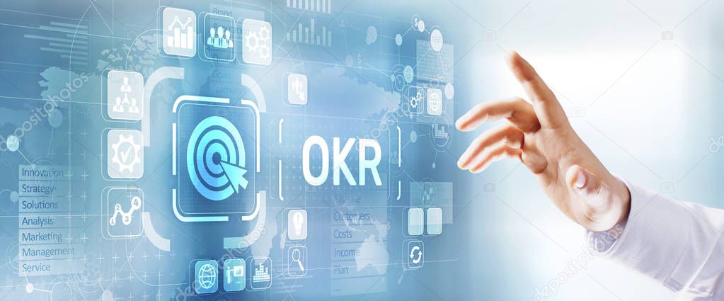 OKR objectives key results business technology concept. Businessman pressing button.