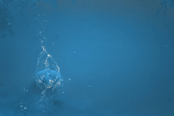 Blue background, motion details showing it is a liquid.