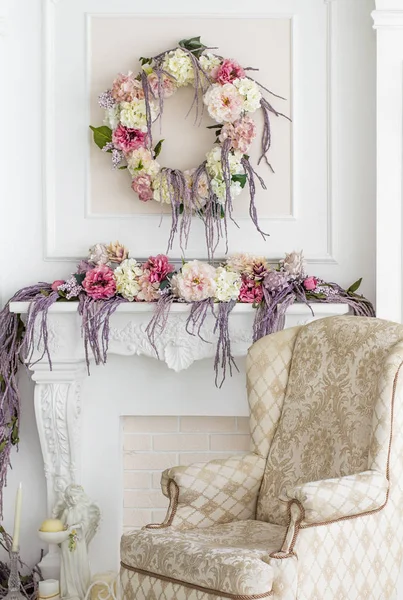 Floral decoration in the photo studio. Interior photo studio. Wedding decorations. Gentle spring flowers. flower composition. Armchair, candle and statuette of an angel