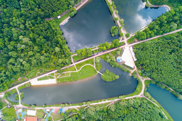 A view of the paths and ponds in Moscow in the park in the summer. Aerial photography.