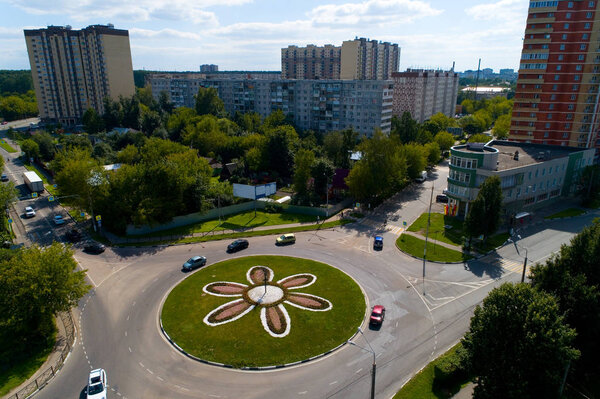Top view of the road with a circular motion and a flower bed. Aerial photography.