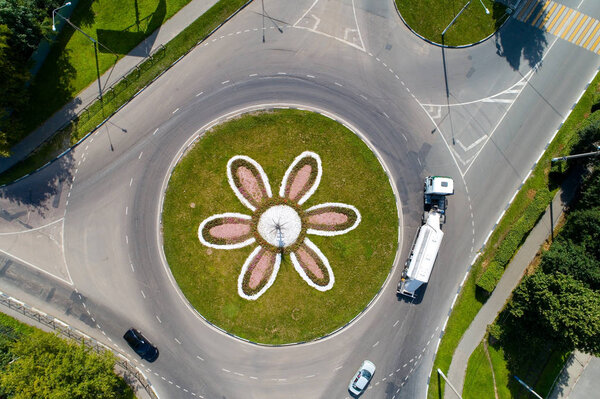 Top view of the road with a circular motion and a flower bed. Aerial photography.