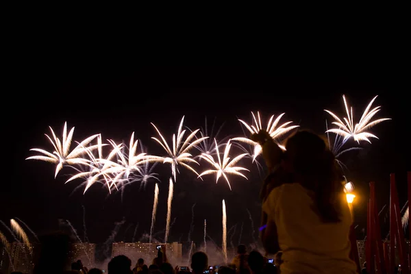 Viewers watch beautiful fireworks in the sky. Moscow.