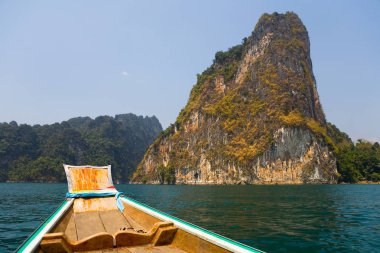 Pitoresk bir su birikintisi üzerinde tekne yelken bir kayalık ada için.