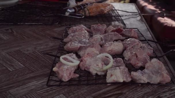 Putting a pickled pork kebab on the barbecue grill — Stock Video