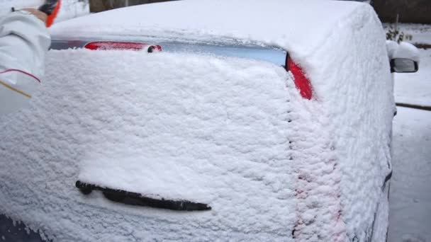 Het reinigen van de auto uit de sneeuw. Slow motion duidelijk — Stockvideo