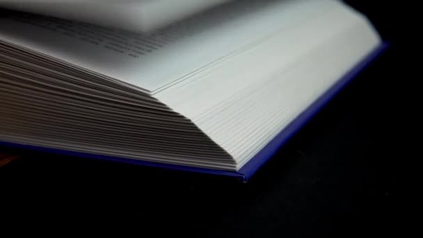 Book turning pages on a black background — Stock Video