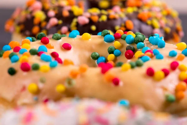 Donut fresco com coberturas em um fundo escuro — Fotografia de Stock