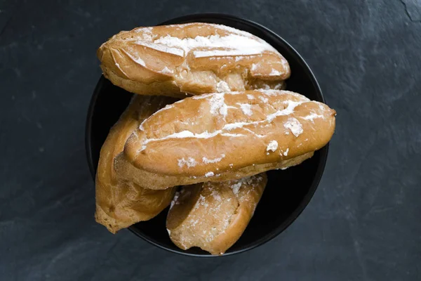 Eclairs with the filling on the plate is a traditional French dessert