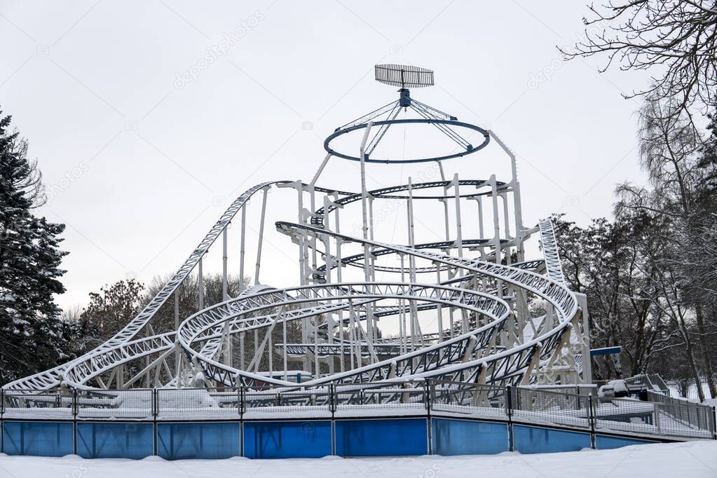 View of snow-covered attractions in the amusement Park on a cold winter day