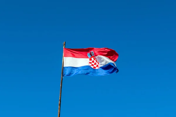 red white blue flag of Croatia against blue sky