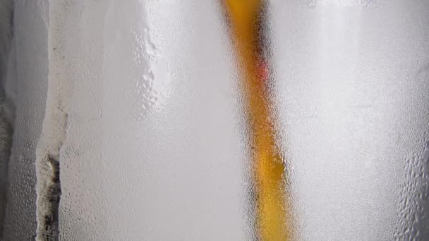 Vitrais de cerveja. um fluxo de cerveja derrama no copo — Vídeo de Stock