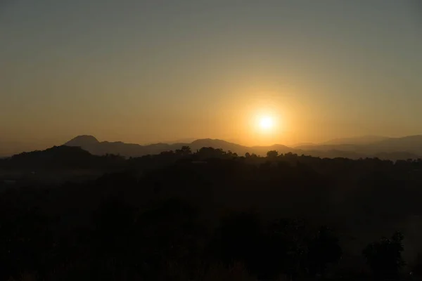 last light of the sun is falling on the mountain in the evening time.