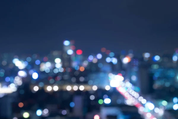 Lights blur from the big city at dark night.